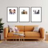 Living room with orange sofa and three framed photos on the wall.